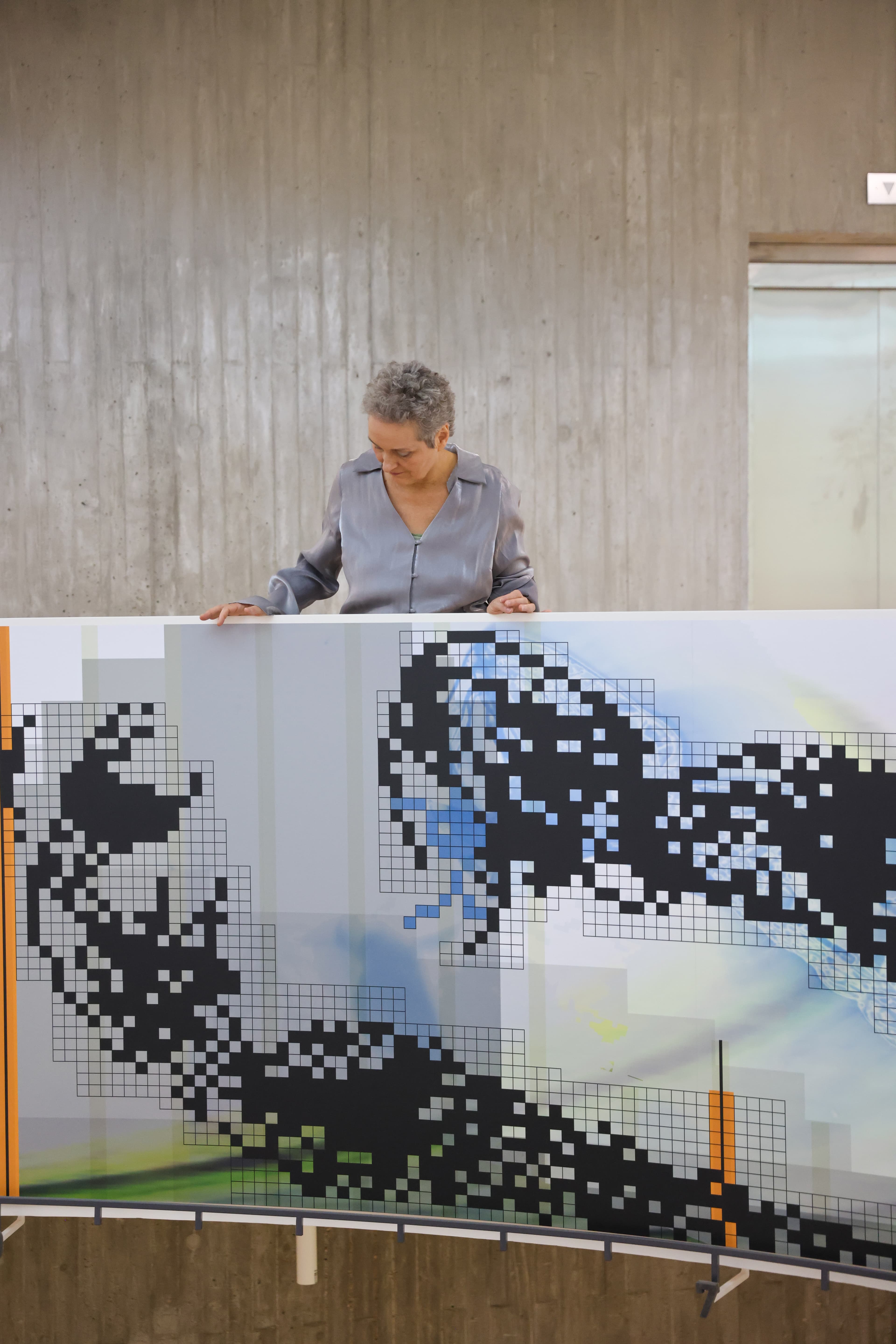 artist looking at the balustrade of the building